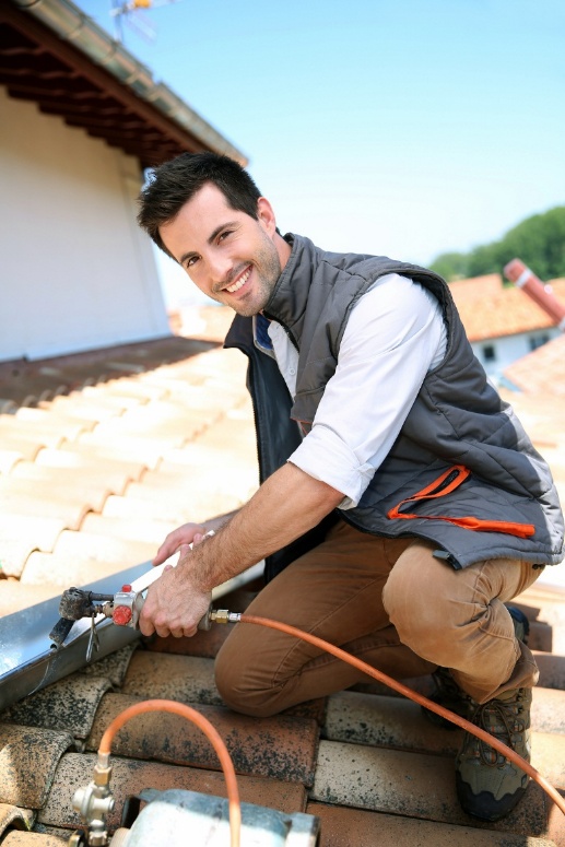 worker fixing gutters